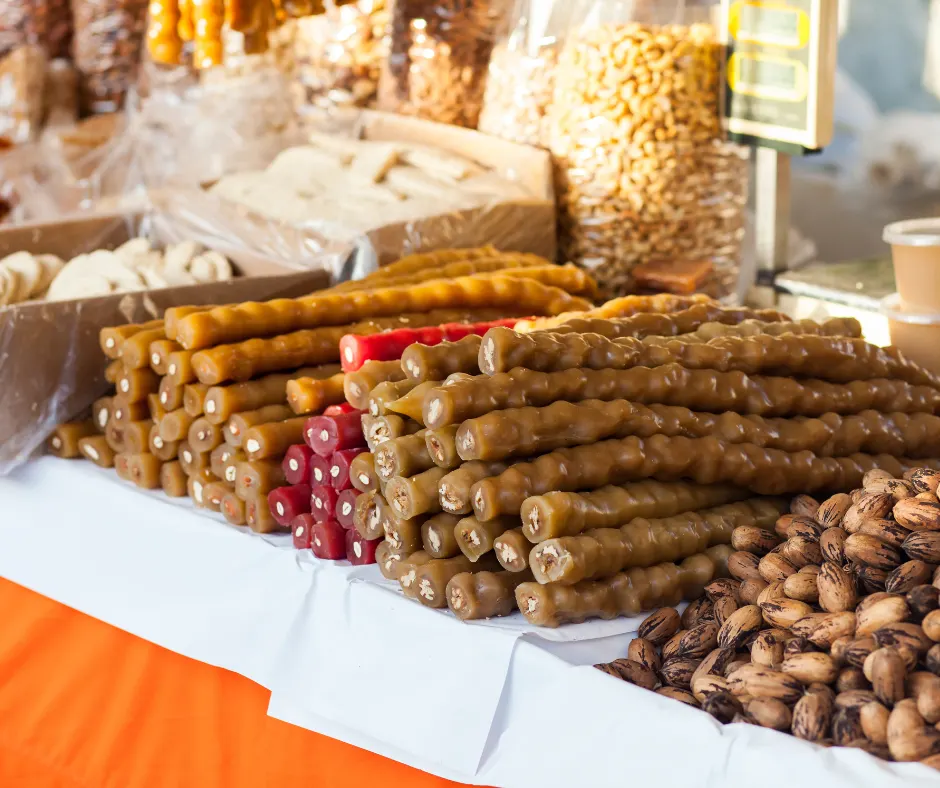 Stacks of soutzoukos and walnuts on a Cypriot festival stall table