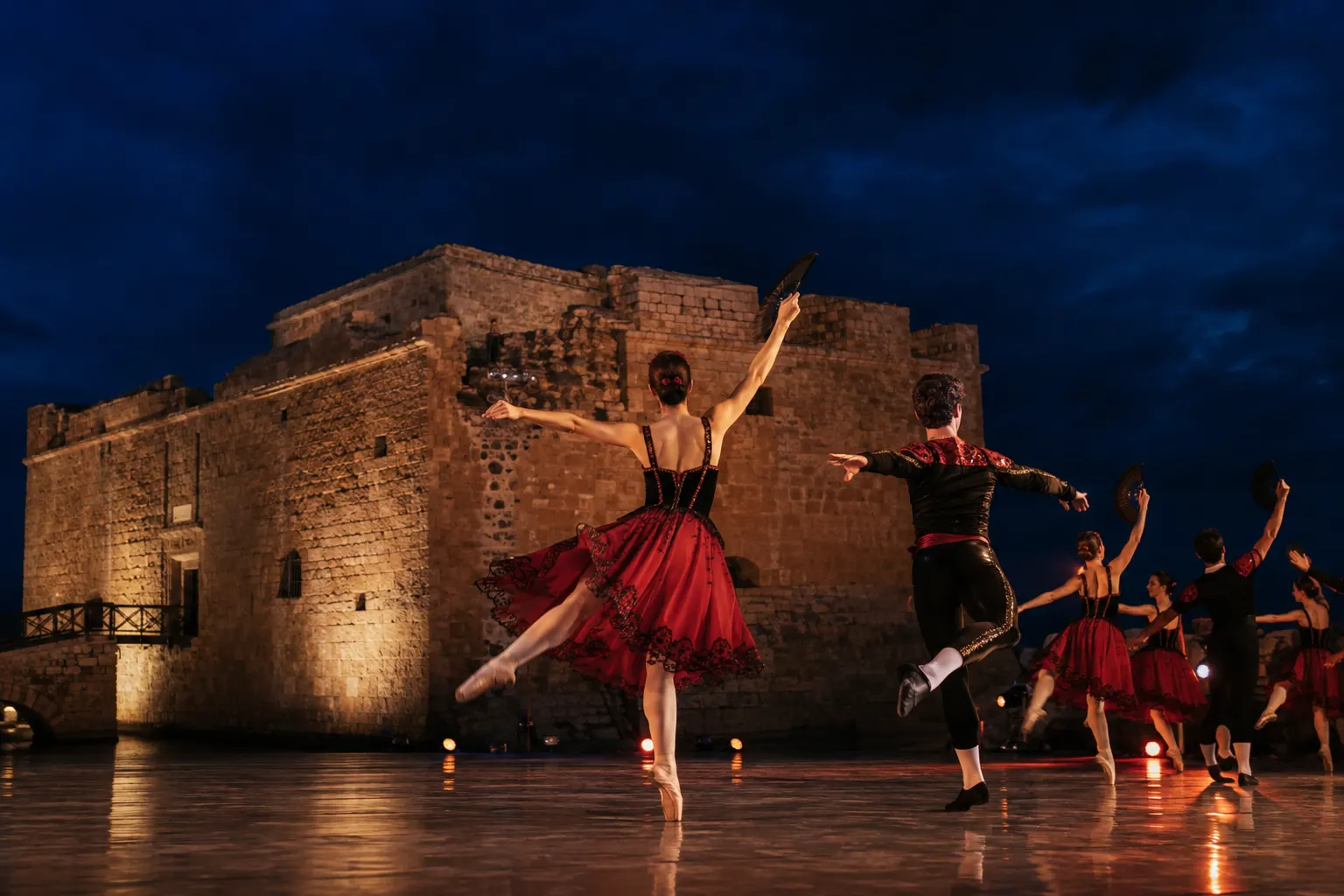 Editorial image of ballet dancers beside a stone castle for Don Quixote in Paphos