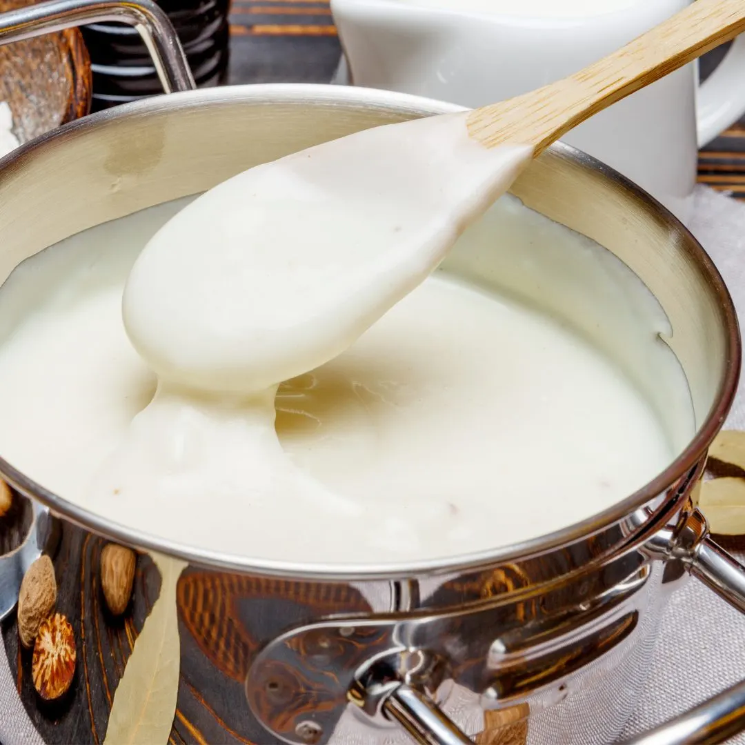 Béchamel poured over the pasta layers